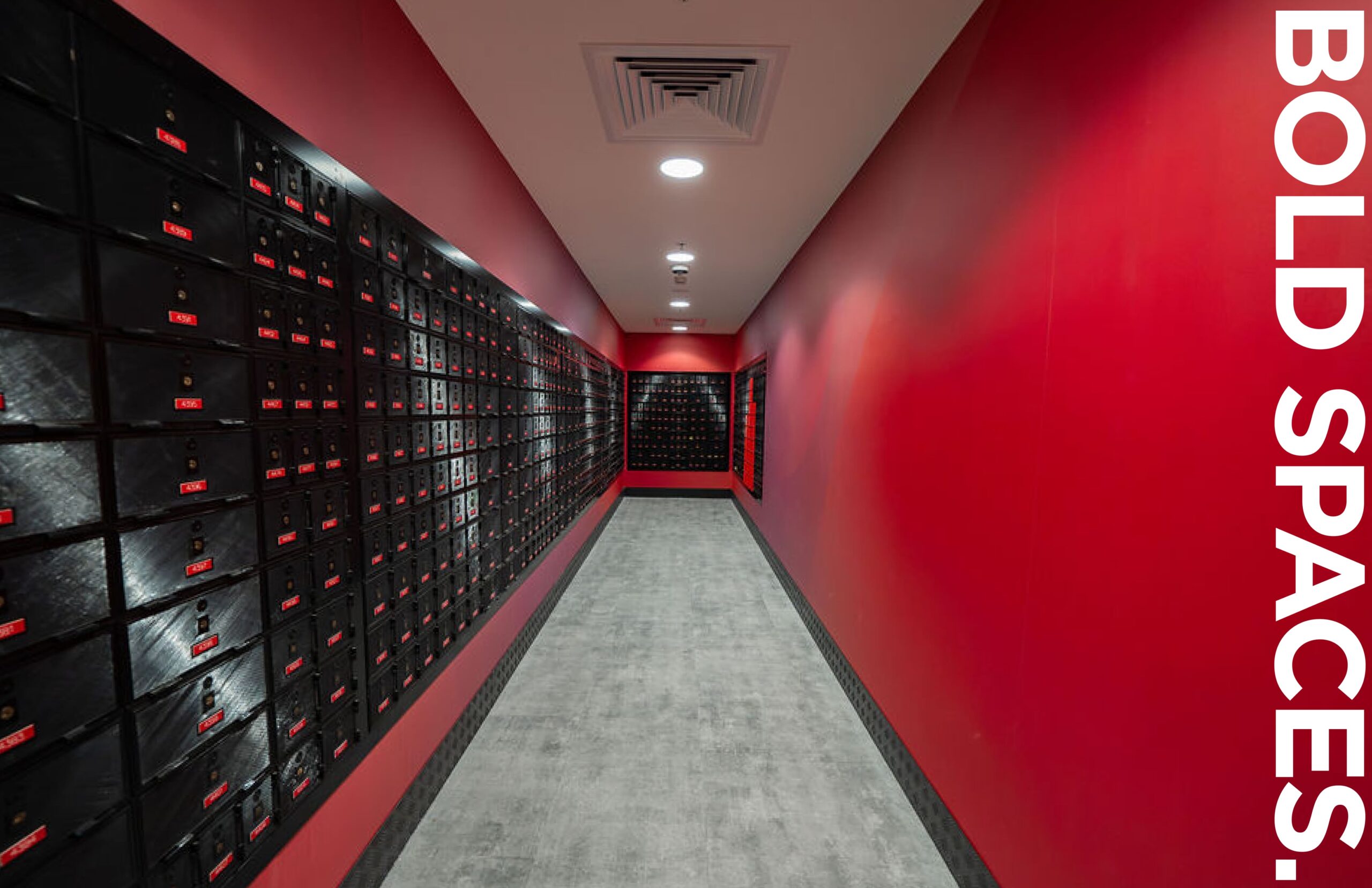 Red hallway with black mailboxes and bold spaces text; modern design in vibrant colors.
