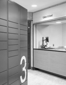 Parcel lockers and Collect & Send counter in modern postal service area.